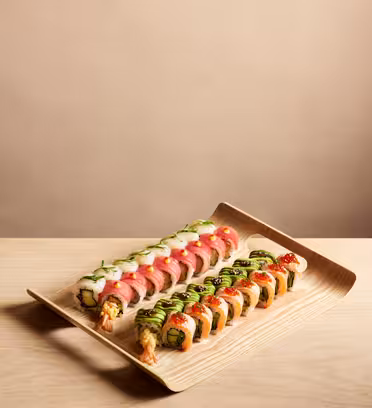 Et fad med to typer sushi ruller på en træoverflade. Rullerne er pænt arrangeret og byder på forskellige skaldyr, avocado og ris, pyntet med saucer og krydderurter. Baggrunden er en blød beige tone.